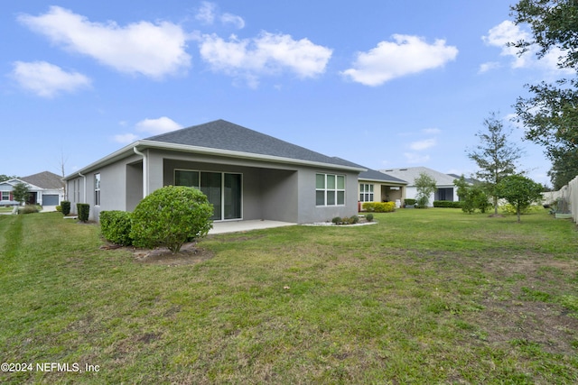 back of house featuring a yard and a patio area