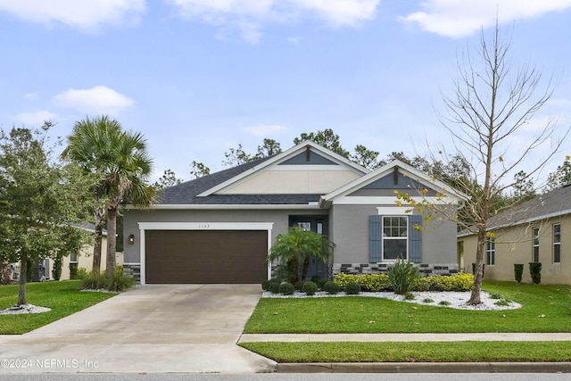 view of front facade featuring a front yard and a garage