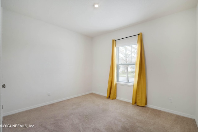 unfurnished room with light colored carpet