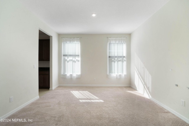 empty room featuring light colored carpet