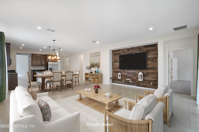 living room featuring a notable chandelier and light tile floors