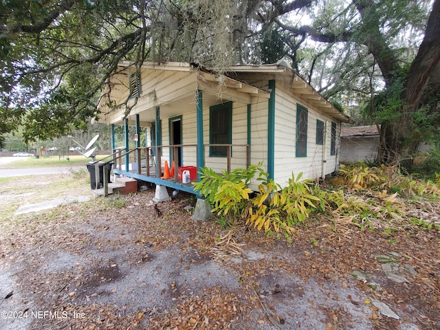 view of side of property with covered porch