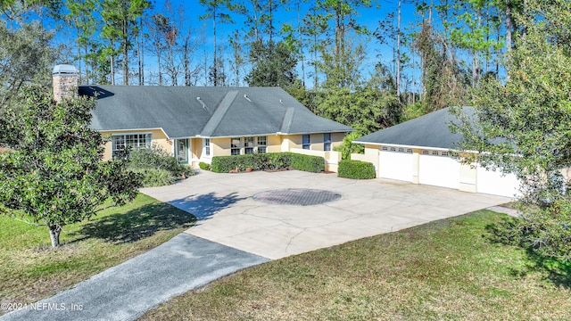 single story home with a front yard and a garage