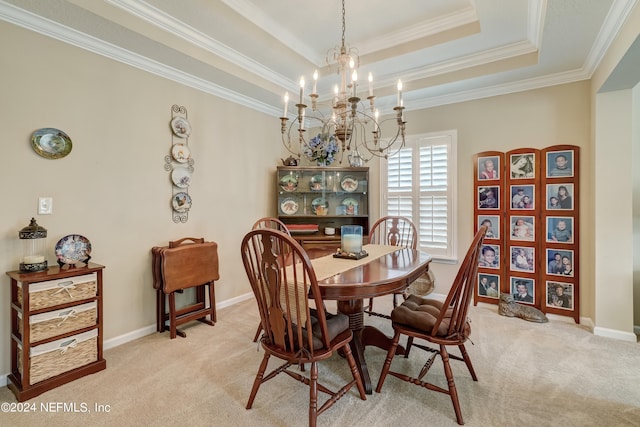 dining area with light carpet, a chandelier, a tray ceiling, and crown molding