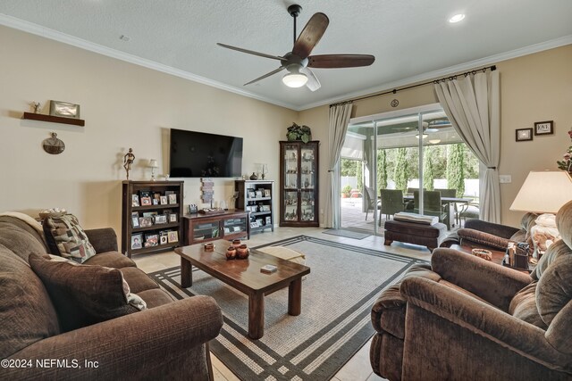 tiled living room featuring ornamental molding, a textured ceiling, and ceiling fan