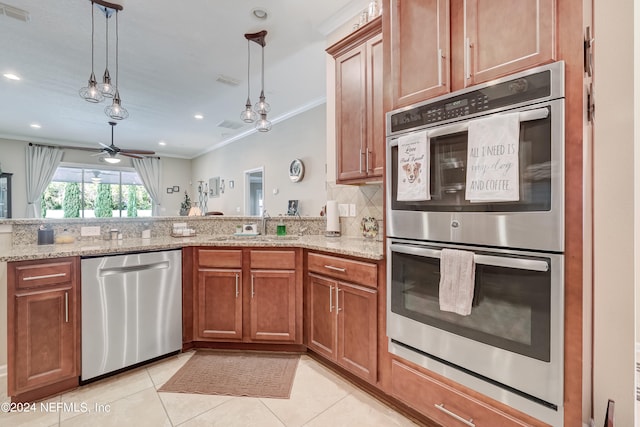 kitchen featuring light stone countertops, decorative light fixtures, ceiling fan, and stainless steel appliances