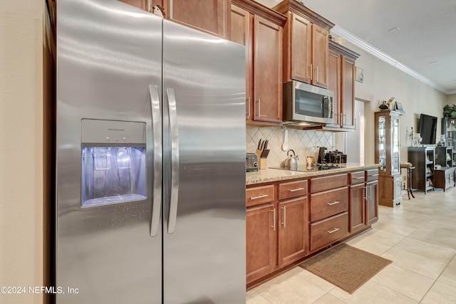 kitchen featuring stainless steel appliances, light tile floors, tasteful backsplash, crown molding, and light stone counters