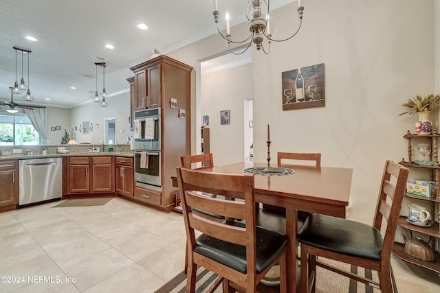 dining room with an inviting chandelier, light tile floors, and ornamental molding