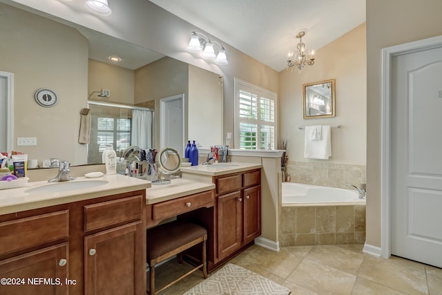 bathroom featuring double sink, vanity with extensive cabinet space, tiled tub, tile flooring, and an inviting chandelier