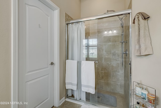 bathroom with a shower with door