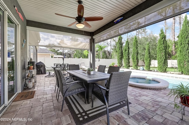 sunroom featuring ceiling fan and a wealth of natural light