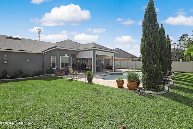 back of property featuring a fenced in pool, a lawn, and a patio