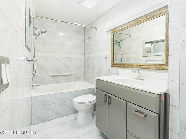 1530 El Prado Rd Unit 5, Jacksonville, FL 32216 - full bathroom featuring vanity, tile walls, tile floors, tiled shower / bath, and toilet
