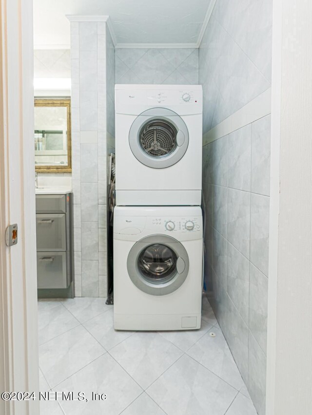 1530 El Prado Rd Unit 5, Jacksonville, FL 32216 - washroom with tile walls, stacked washer / dryer, and light tile floors