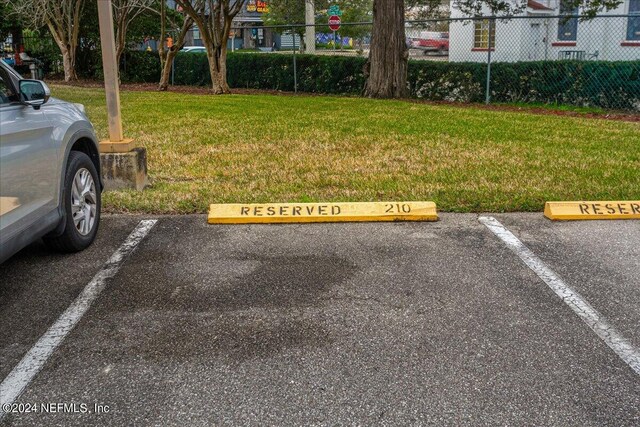 view of car parking with a lawn