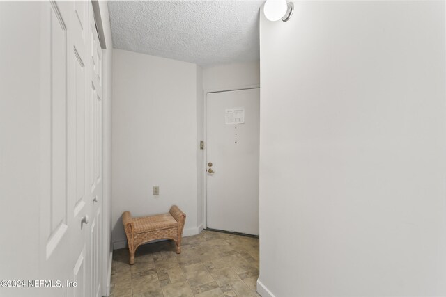 interior space featuring a textured ceiling and light tile patterned flooring