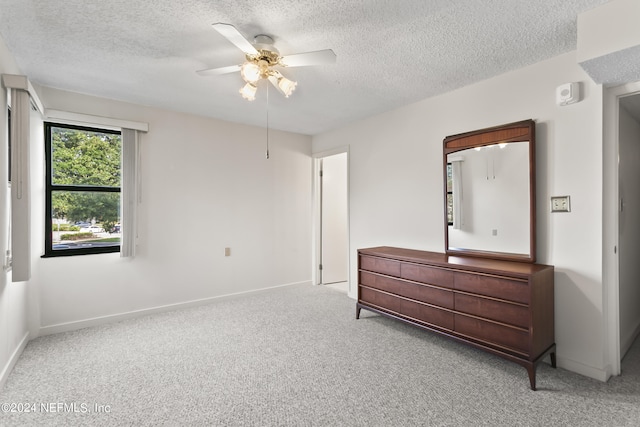 bedroom with ceiling fan, a textured ceiling, and carpet floors