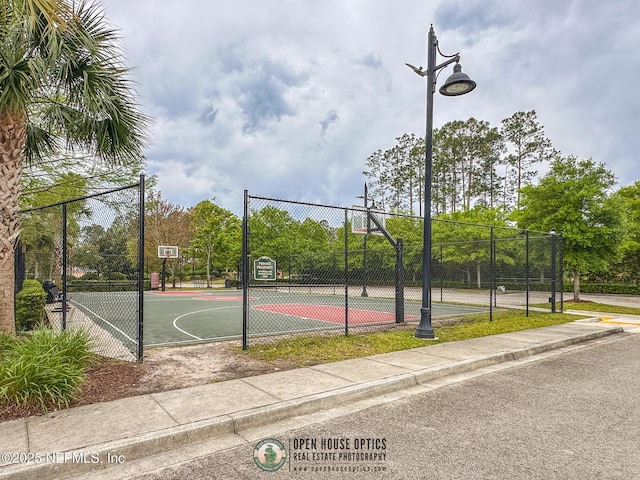 view of basketball court featuring community basketball court and fence