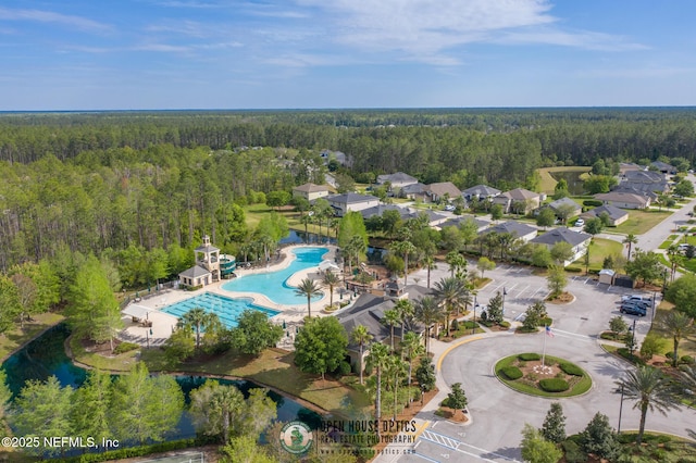 birds eye view of property featuring a view of trees
