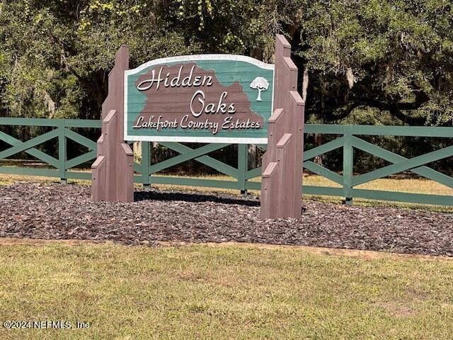 community / neighborhood sign with a yard