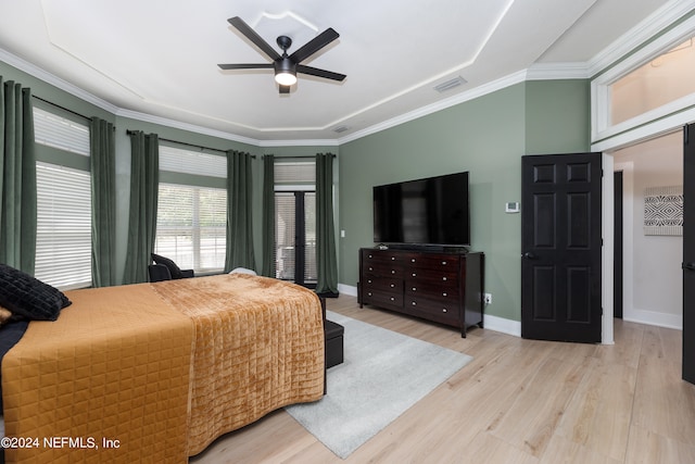 bedroom with ornamental molding, ceiling fan, and light wood-type flooring