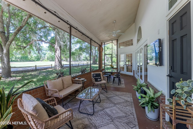 sunroom / solarium with lofted ceiling and ceiling fan