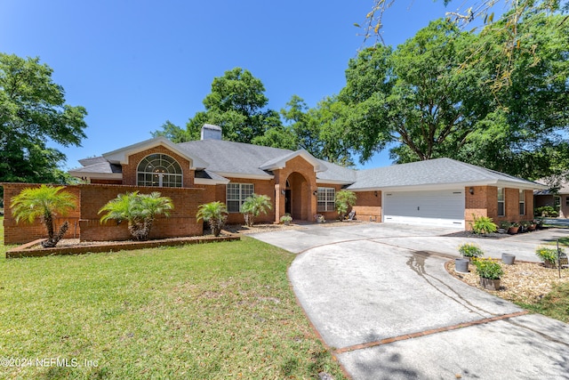 ranch-style home featuring a front lawn and a garage