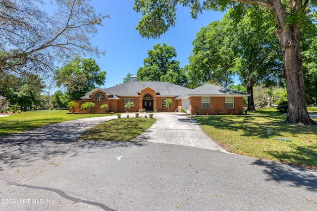 ranch-style home with a front lawn