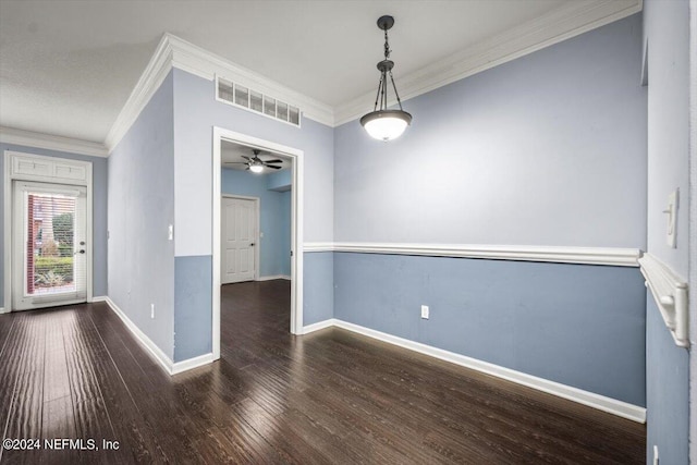 empty room with crown molding and dark wood-type flooring