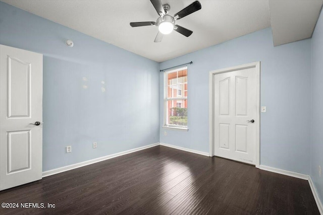 unfurnished room featuring dark hardwood / wood-style floors and ceiling fan