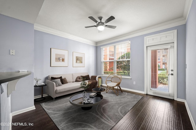 living room featuring crown molding, ceiling fan, dark hardwood / wood-style flooring, and a textured ceiling