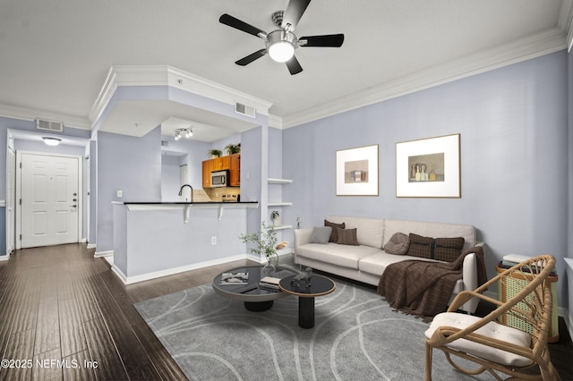 living room with ceiling fan, ornamental molding, dark hardwood / wood-style flooring, and sink