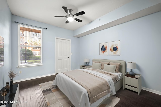 bedroom with ceiling fan and dark hardwood / wood-style flooring