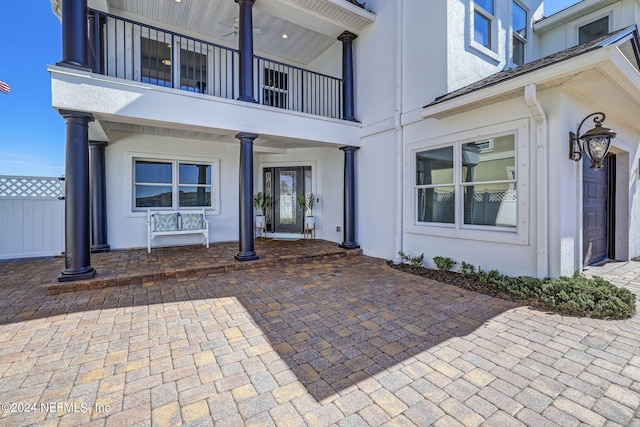 doorway to property with a balcony and a patio