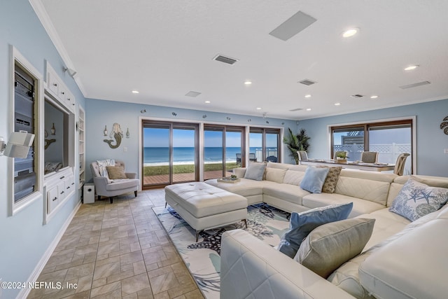 living room featuring crown molding, a water view, and light tile floors