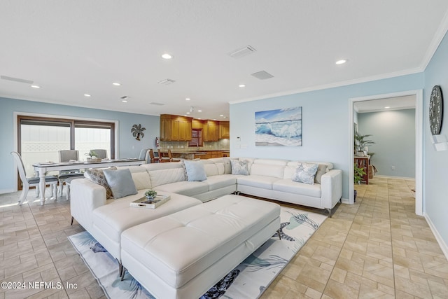 living room featuring light tile floors and crown molding