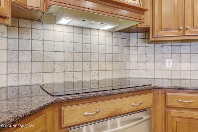 kitchen with tasteful backsplash, black electric cooktop, custom exhaust hood, and dark stone counters