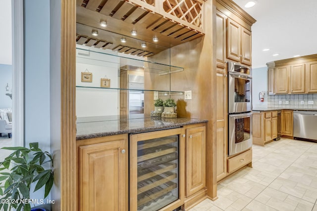 interior space with double oven, dishwashing machine, wine cooler, tasteful backsplash, and dark stone countertops