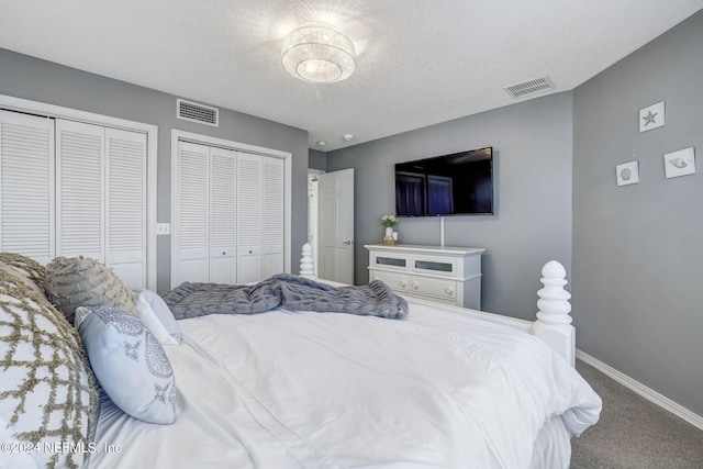 bedroom featuring carpet floors and two closets