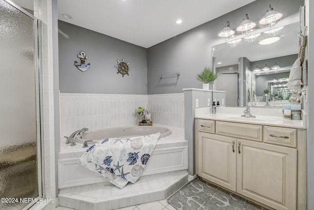 bathroom with tile floors, independent shower and bath, and large vanity