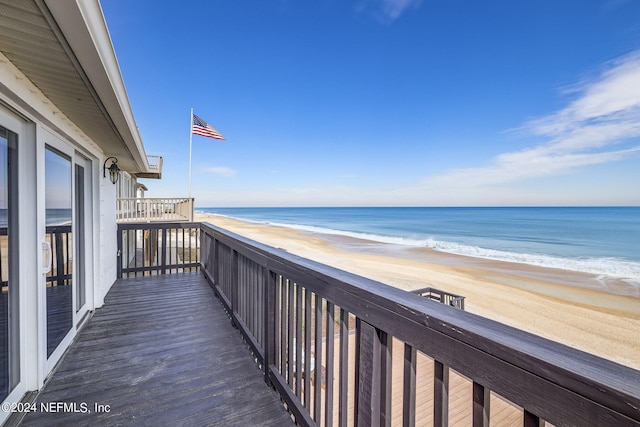 balcony with a beach view and a water view