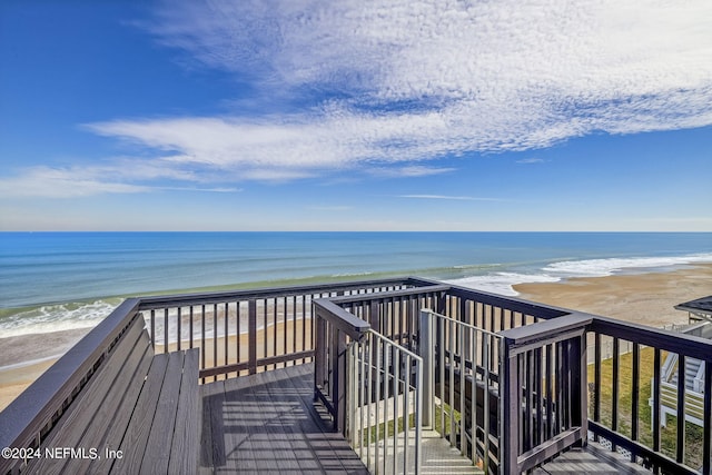 wooden terrace with a water view and a beach view