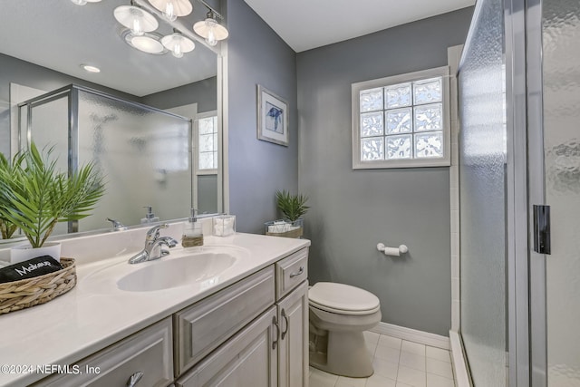 bathroom featuring vanity, an inviting chandelier, tile floors, a shower with door, and toilet