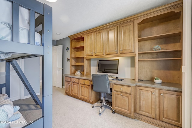 office featuring light colored carpet and built in desk