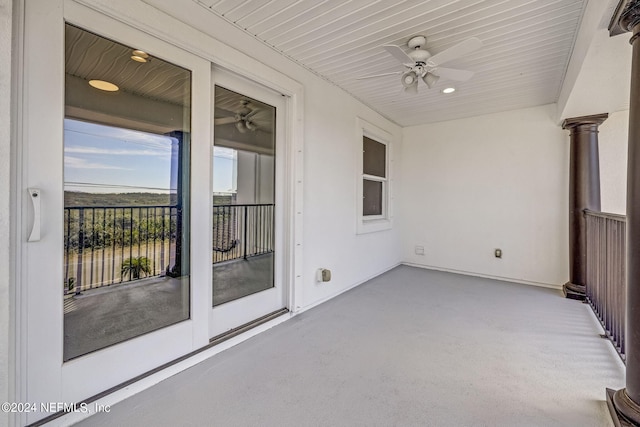 unfurnished sunroom with ceiling fan