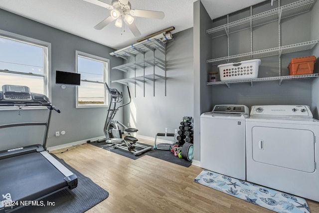 washroom with washing machine and clothes dryer, light hardwood / wood-style floors, and ceiling fan