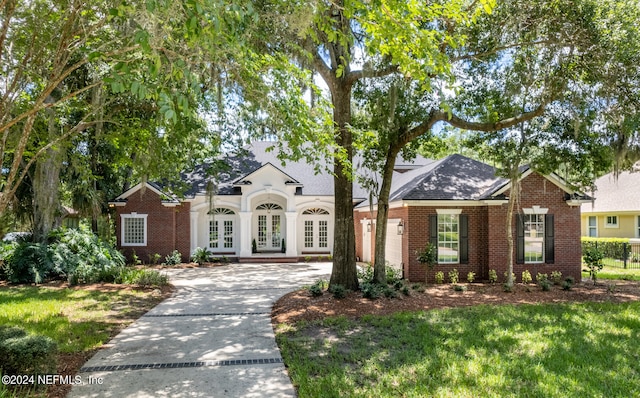 single story home featuring a garage and french doors