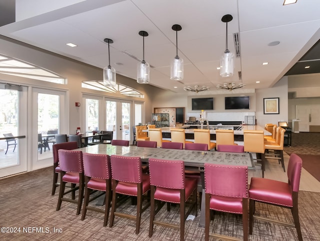 bar with hanging light fixtures, hardwood / wood-style flooring, and french doors