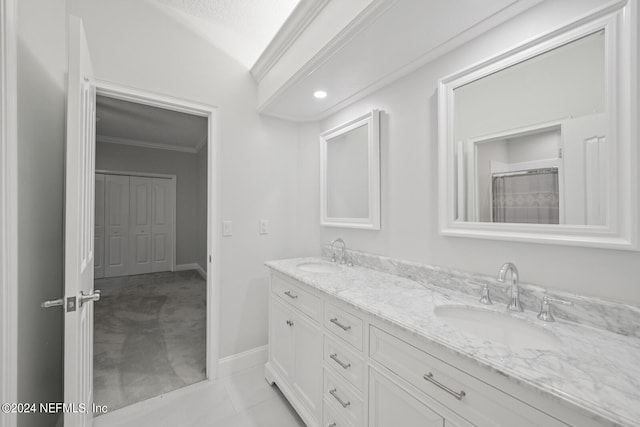 bathroom with ornamental molding, vanity, lofted ceiling, and tile patterned flooring