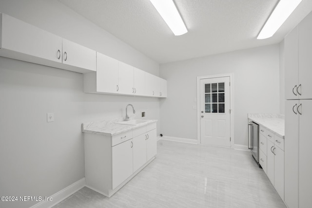 interior space with a textured ceiling and sink